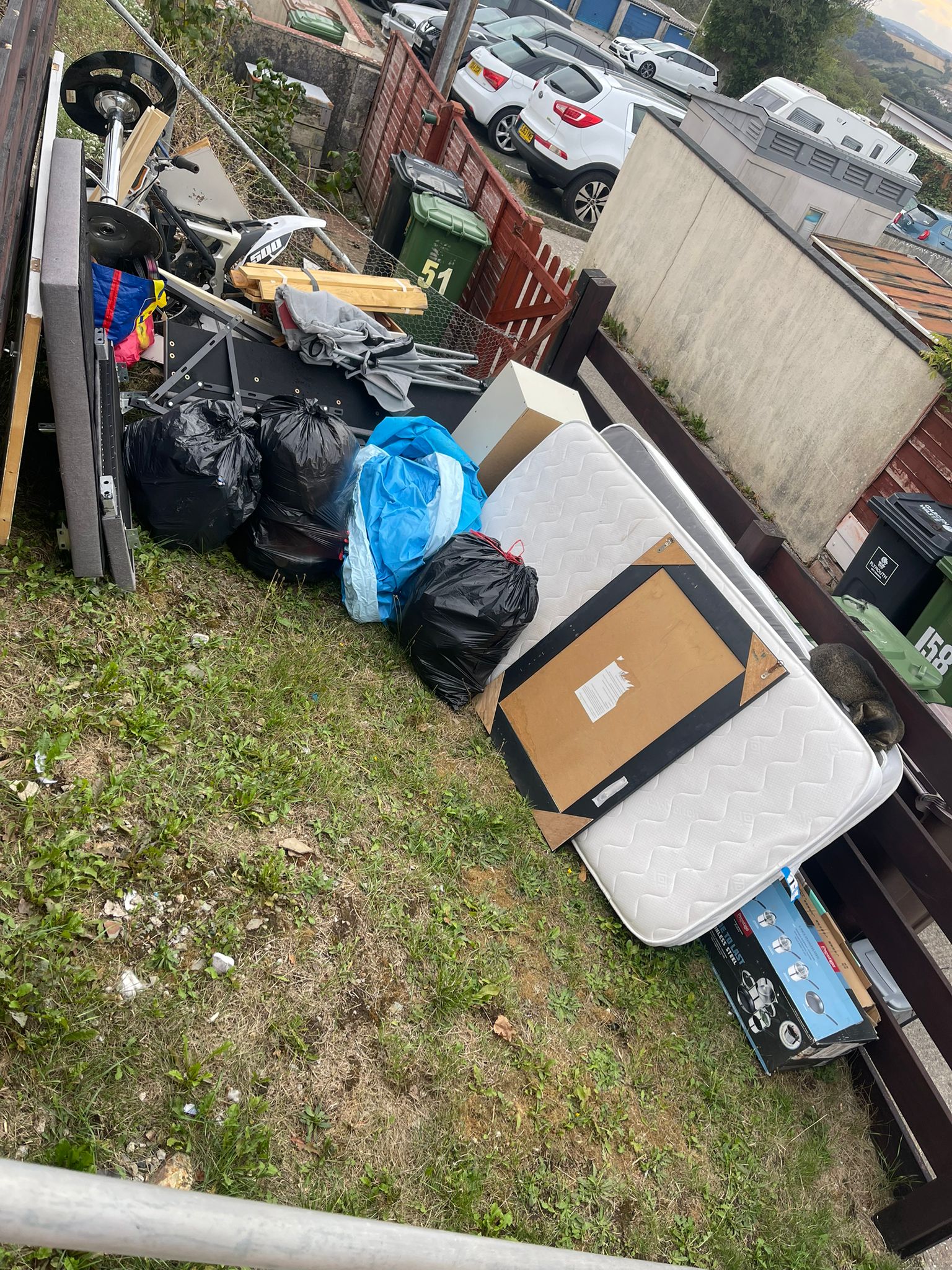 Mixed bulky waste, bags, timber and a mattress ready for collection